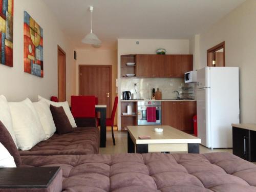 a living room with a couch and a kitchen at PSB Apartments in Midia Resort Aheloy in Aheloy
