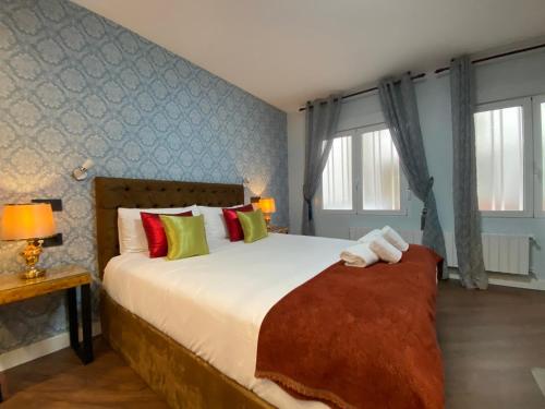 a bedroom with a large bed and a window at Charming Plaza de España in Madrid