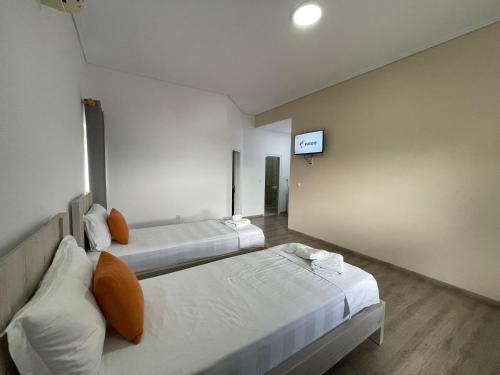 Una cama o camas en una habitación de Relax Mea Hotel