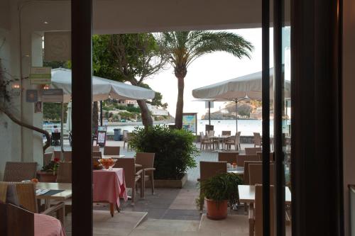 a view of a restaurant with tables and umbrellas at Los Geranios in Port de Soller