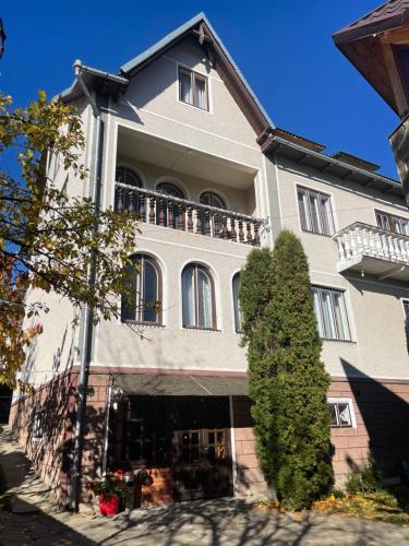 a large building with a balcony on top of it at Sadyba Girske Povitria in Yaremche