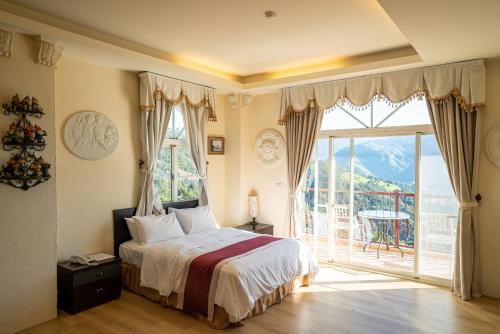 a bedroom with a bed and a large window at Qingjing Baiyun Resort in Renai