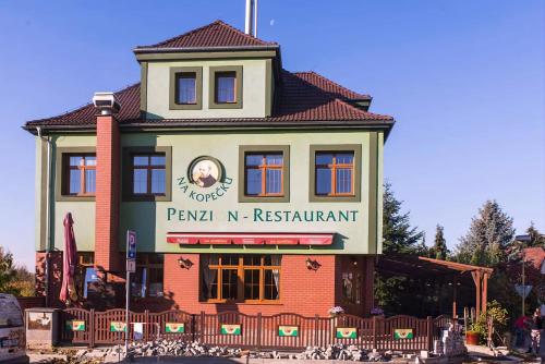 a building with a sign that reads paulinian n restaurant at Kopeček - Penzion in Česká Lípa