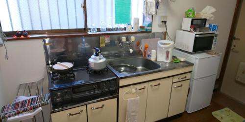 a small kitchen with a sink and a stove at Yagisawa Corp - Vacation STAY 90026v in Nikko