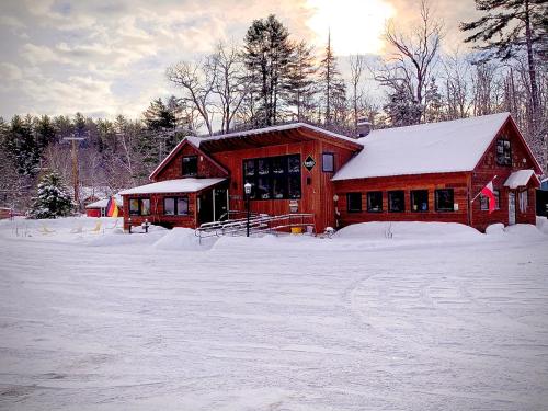 a red barn with snow on the ground at Gore Mountain Lodge in North Creek