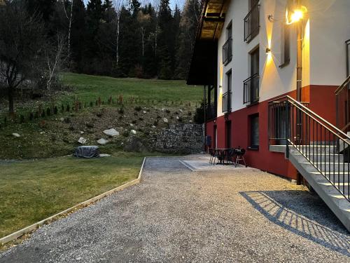 a patio of a building with a table and a bench at Apartamenty Carpe Diem in Ustroń