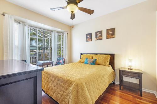 Un dormitorio con una cama y un ventilador de techo. en Luxury Waterfront Villa - Heated Pool and Spa with Direct Gulf Access - American Dream - Roelens, en Cabo Coral