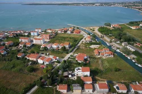 an aerial view of a small town next to the water at Apartments and bungalows vila Dalibor in Nin