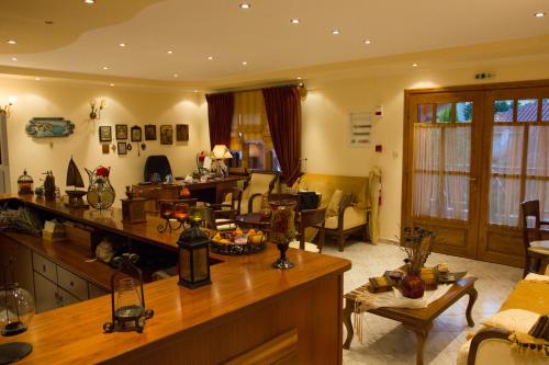 a living room with a kitchen and a living room at Hotel Ismini in Ammouliani