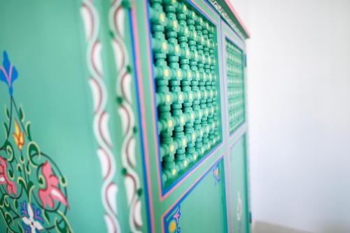 ein Schrank voller grüner und weißer Gerichte in der Unterkunft Riad Dar Rabiaa in Rabat