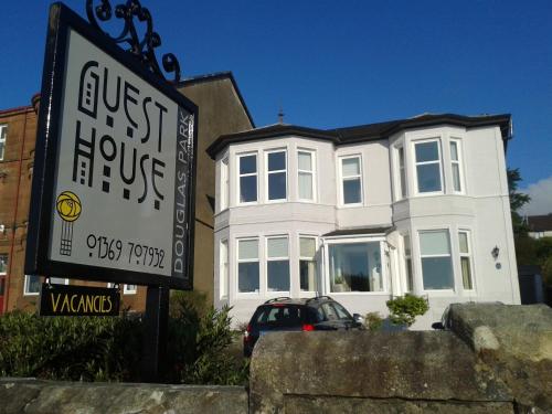 a white house with a sign in front of it at Douglas Park Guest House in Dunoon