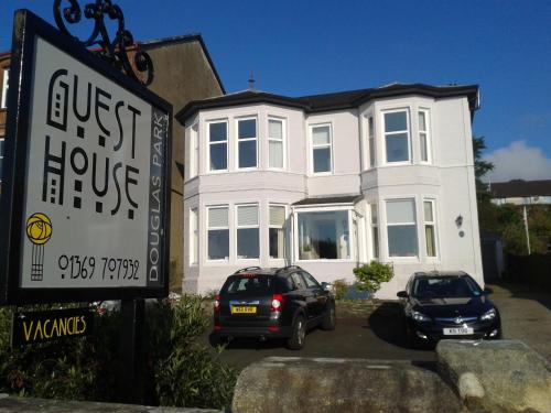 a white house with two cars parked in front of it at Douglas Park Guest House in Dunoon