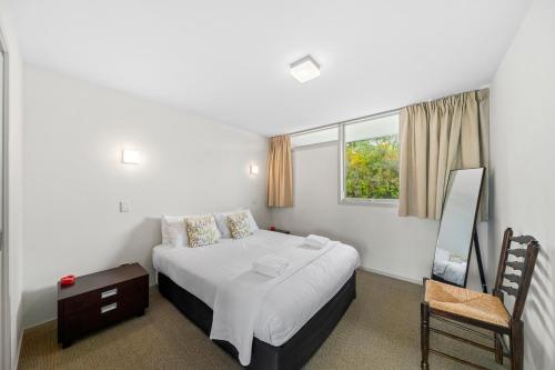 a bedroom with a large bed and a window at Affordable One Bedroom Apartment Lake Taupo C4 in Taupo