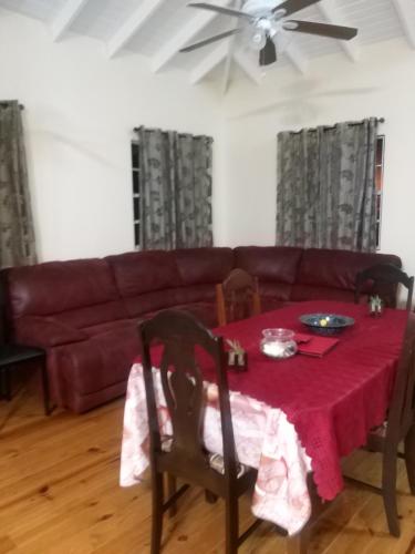 a living room with a table and a couch at Fitzy Haven in Gros Islet