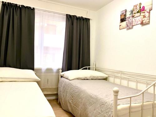 a bedroom with two beds and a window at City Center Premium Apartment - Buchs SG in Buchs