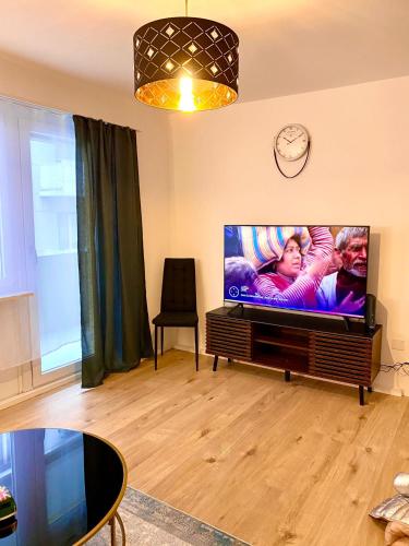 a living room with a large flat screen tv at City Center Premium Apartment - Buchs SG in Buchs