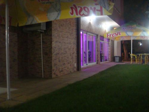 a room with purple lights on the side of a building at Ivatea Family Hotel in Ravda
