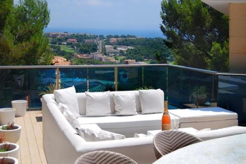 a white couch sitting on top of a balcony at Villa Ocean View in Portals Nous