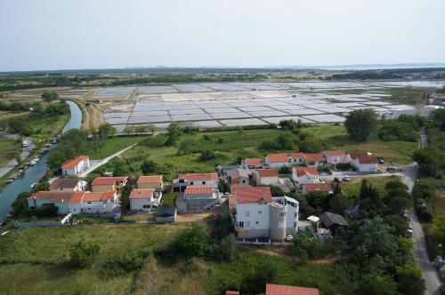 an aerial view of a village next to a river at Apartments and bungalows vila Dalibor in Nin
