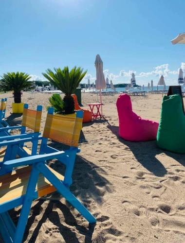 a group of chairs on a sandy beach at A-33-Sea View Studio Apartment Sarafovo in Burgas City