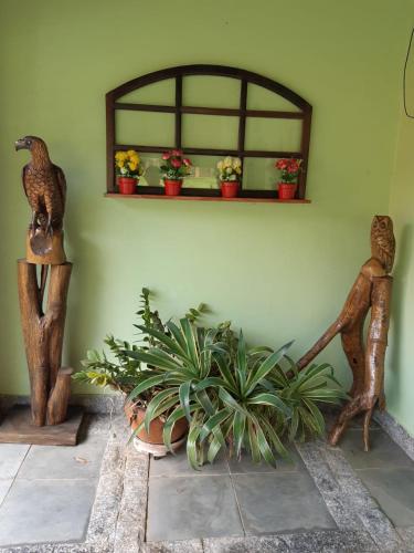 a room with some plants and a shelf with plants at Casa de Campo "Recanto Céu Azul" in Guararema
