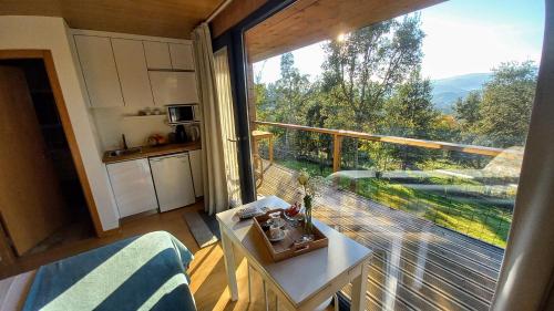 a room with a large window in a tiny house at Horizonte Monte Verde in Mondim de Basto
