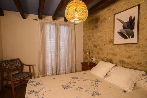 Cervera del MaestreにあるCasa Palmira. Casa de pueblo con encantoのベッドルーム1室(ベッド1台、シャンデリア付)