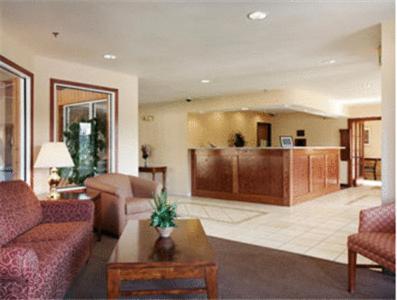 a living room filled with furniture and a large window at Baymont by Wyndham Yreka in Yreka