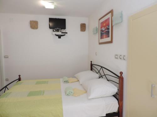 1 dormitorio con 1 cama y TV en la pared en Studio Josip, en Split