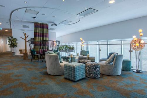 a lobby with couches and chairs and a table at Radisson Blu Hotel Uppsala in Uppsala