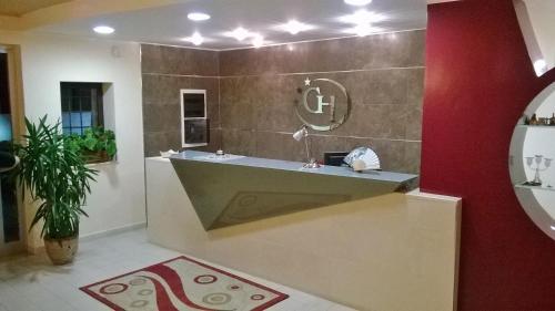 a bathroom with a sink and a red wall at Hotel Ginevra in Poggiomarino