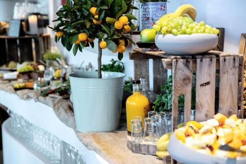 a buffet with oranges and a bowl of fruit at Radisson Blu Hotel Uppsala in Uppsala