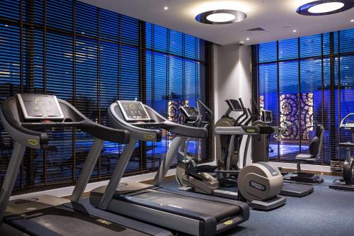a gym with treadmills and ellipticals in a building at Radisson Blu Hotel, Nairobi Upper Hill in Nairobi