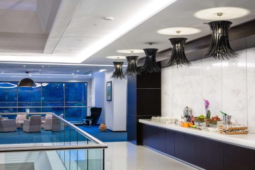 a lobby with blue walls and black chandeliers at Radisson Blu Hotel, Nairobi Upper Hill in Nairobi