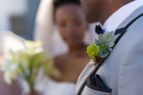 a groom with a flower on the side of a car at Radisson Blu Hotel, Nairobi Upper Hill in Nairobi