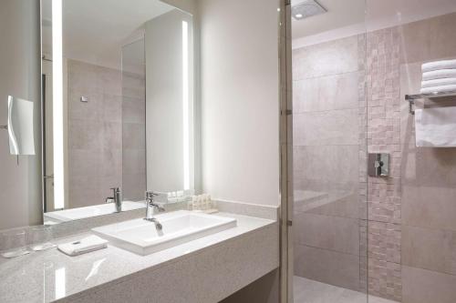 a bathroom with a sink and a shower at Radisson Blu Hotel, Nairobi Upper Hill in Nairobi