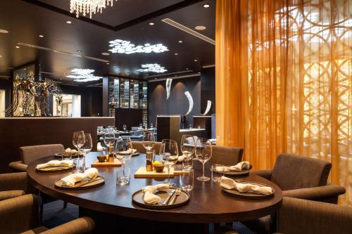 a dining room with a table with wine glasses at Radisson Blu Hotel, Nairobi Upper Hill in Nairobi