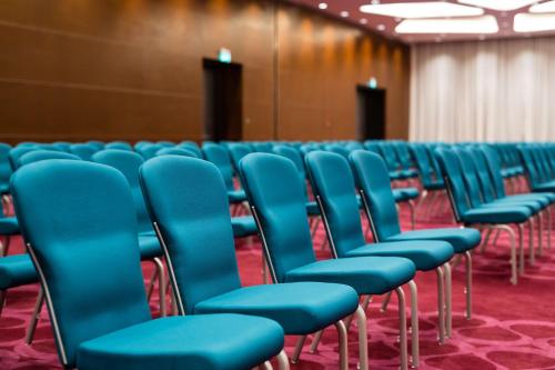 a row of blue chairs in a room at Radisson Blu Hotel, Nairobi Upper Hill in Nairobi