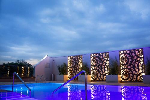 a swimming pool at night with purple lights at Radisson Blu Hotel, Nairobi Upper Hill in Nairobi