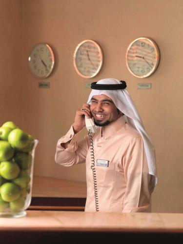 a man is talking on a cell phone at Radisson Blu Hotel, Yanbu in Yanbu