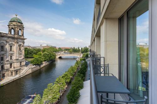a bridge over a river with a clock tower at Radisson Collection Hotel, Berlin in Berlin