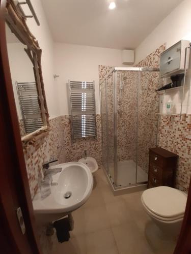 a bathroom with a toilet and a sink and a shower at Il Rifugio Del Conte in Bari