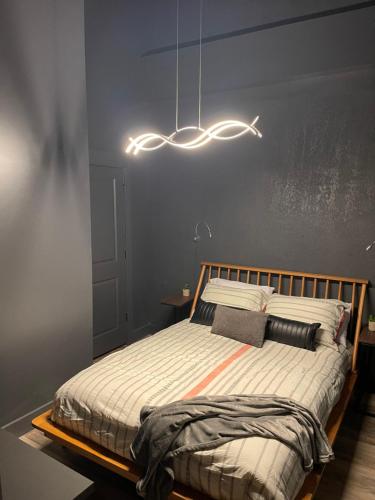 a bedroom with a bed with a wooden frame at City Loft Escape with River Views! By Hollyhock in Louisville