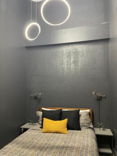 a bedroom with a bed with a yellow pillow at City Loft Escape with River Views! By Hollyhock in Louisville