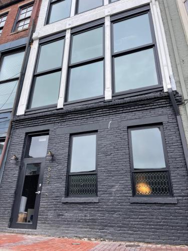 a brick building with many windows on it at City Loft Escape with River Views! By Hollyhock in Louisville