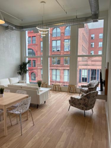 a large living room with a couch and chairs at Lou-City Penthouse Suite! Savor Life with Hollyhock in Louisville