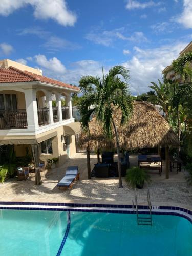 a swimming pool in front of a house at Beach Aqualina Apartments in Fort Lauderdale