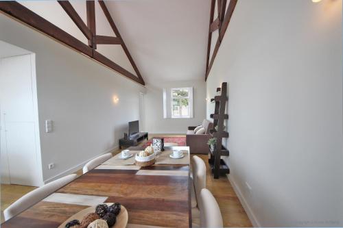 a living room with white walls and wooden beams at Oporto River and Ribeira Views in Vila Nova de Gaia