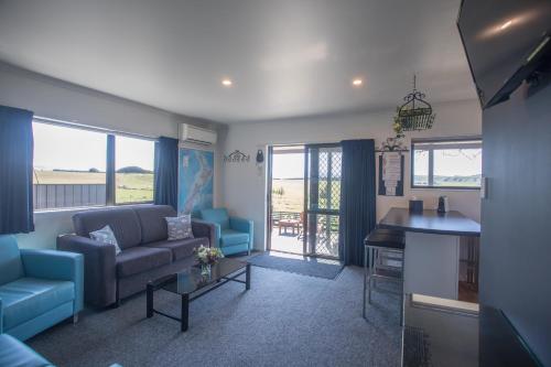 una sala de estar con un sofá y una mesa en Shearvue Farmstay with Optional Free Farm Experience at 5pm, en Fairlie