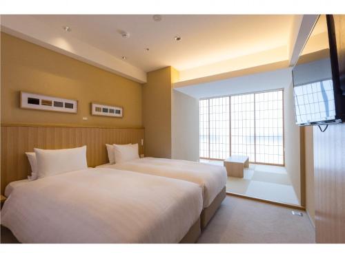 Postel nebo postele na pokoji v ubytování 9 HOTEL Hakata
